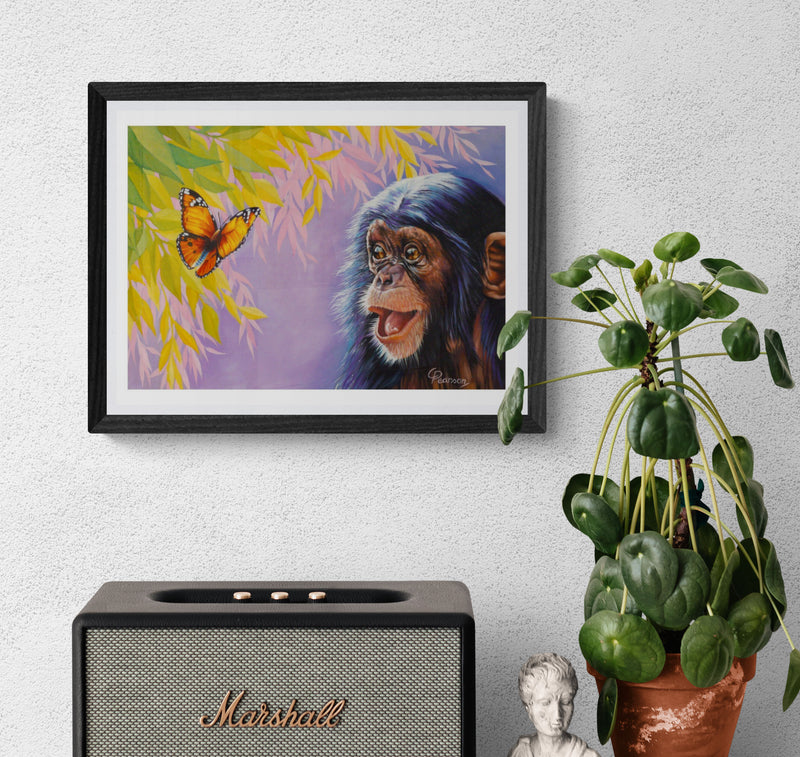 Framed artwork of a chimpanzee and butterfly on a wall above a Marshall speaker with a plant beside it.