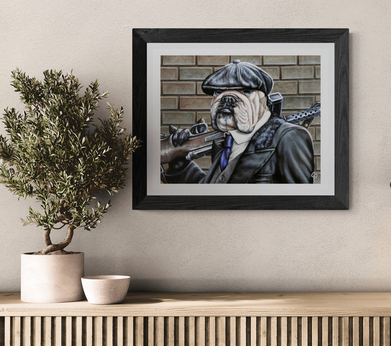 Framed artwork of a dog in a military uniform on a wall above a wooden shelf with decorative items.
