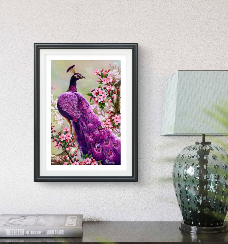 Framed artwork of a purple peacock in a floral setting on a wall above a table with a lamp.