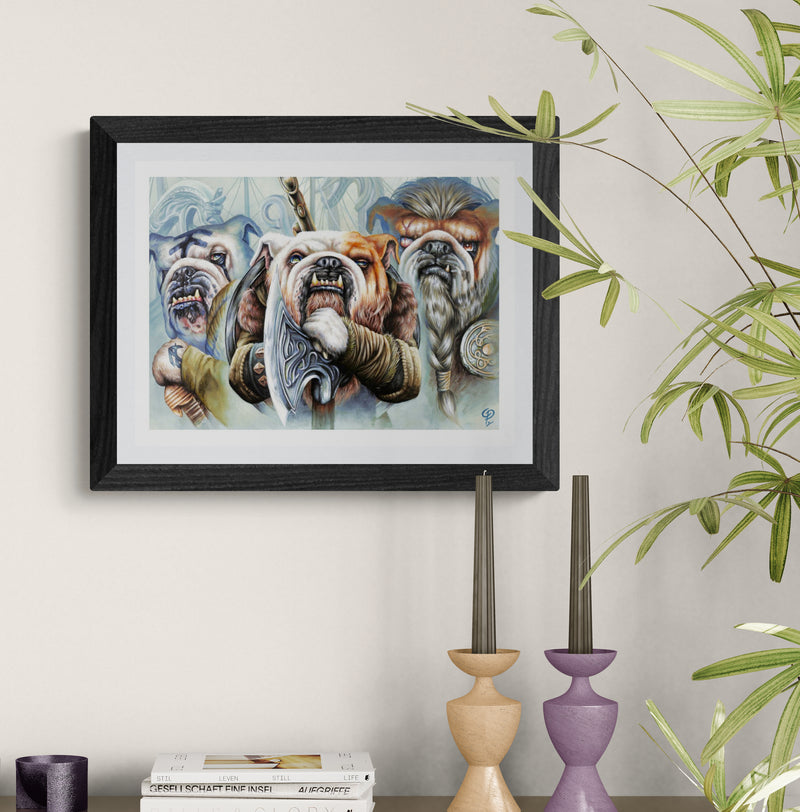Framed artwork of bulldogs on a wall with decorative candles and books below.
