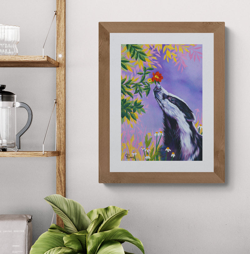 Framed painting of a badger with flowers on a wall above a plant