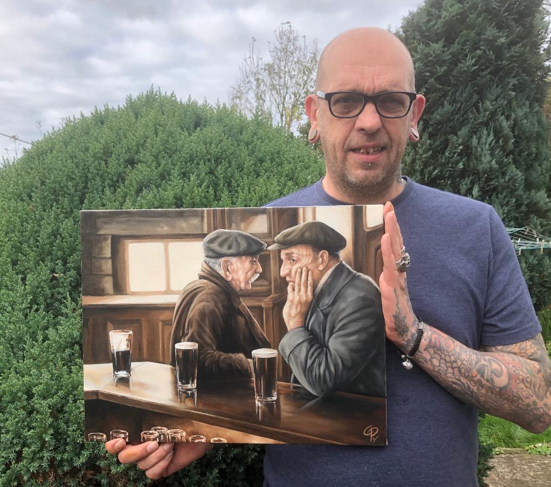 chris pearsn holding oil painting