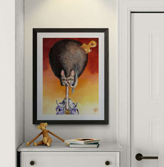 Framed artwork of a cat playing a guitar on a wall above a white dresser with a small figurine and books.