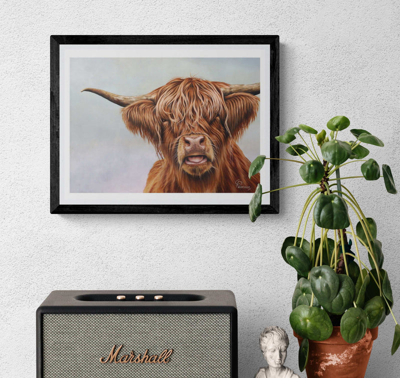 Framed artwork of a highland cow above a Marshall speaker with a plant on a white wall.