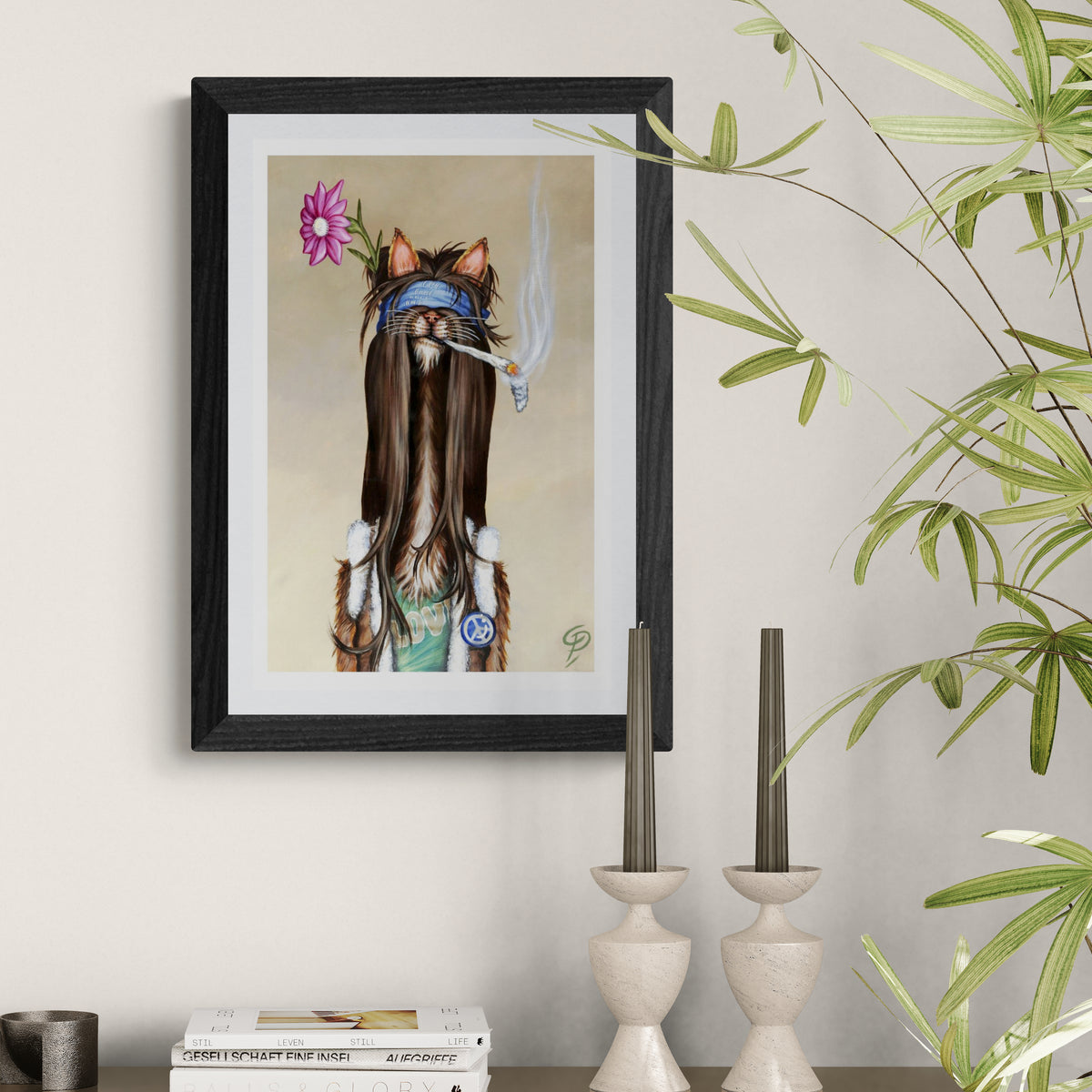 Framed artwork of a cat with long hair, flowers, and a blue bandana on a wall.