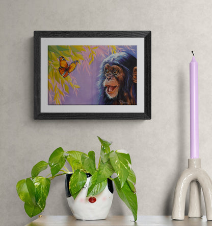 Framed artwork of a monkey and butterfly on a wall with decorative items below.