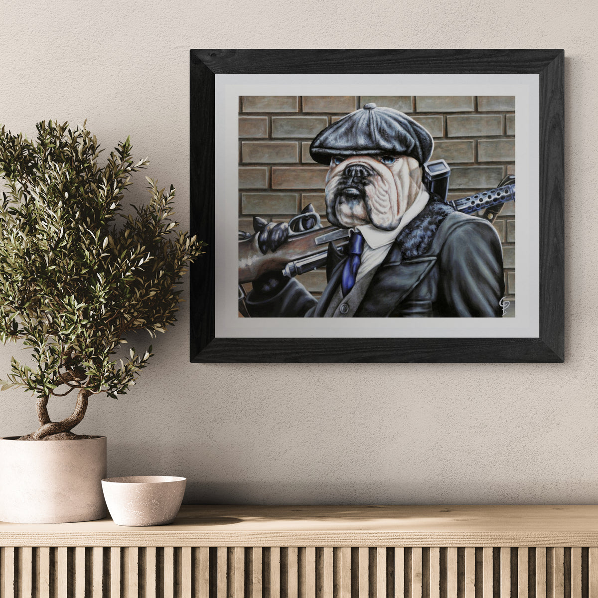 Framed artwork of a dog in a military uniform on a wall above a wooden shelf with decorative items.