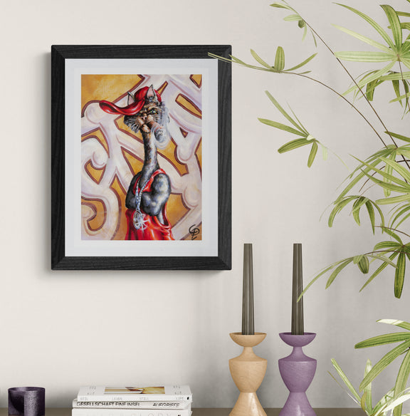 Framed artwork of cat  on a wall with decorative candles and books below
