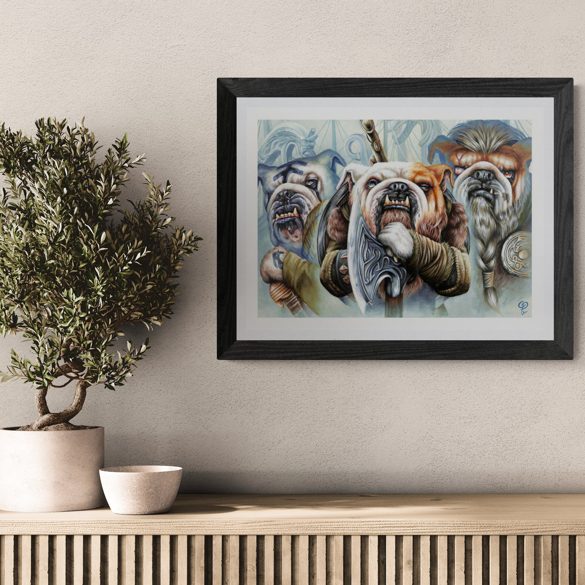 Framed artwork of bulldogs on a wall with decorative candles and books 